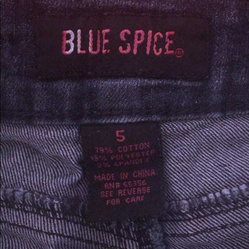 A red tube top w a pair of ripped jeans